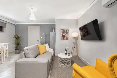 a living room with a couch and a table at Marasi Apartment - Islander's Home Collection in Rhodes Town
