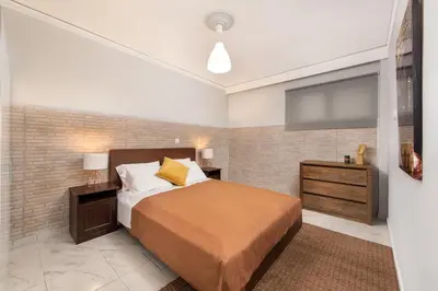 a bedroom with a bed and a television at Marasi Apartment - Islander's Home Collection in Rhodes Town