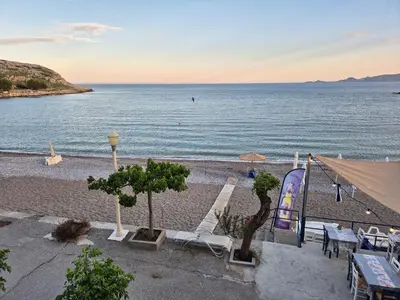 a view of a beach with chairs and umbrellas at Anastasia Beach House Haraki in Rhodes Town