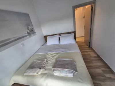 a bed in a room with two towels on it at Anastasia Beach House Haraki in Rhodes Town