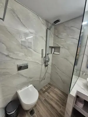 a bathroom with a shower and a toilet and a sink at Anastasia Beach House Haraki in Rhodes Town