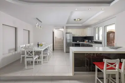 a kitchen and dining room with a table and chairs at Paradise Beach I in Kiotari