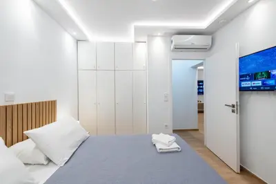 a bedroom with a bed and a tv on the wall at Hella apartment in Rhodes Town