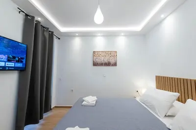 a bedroom with a bed and a flat screen tv at Hella apartment in Rhodes Town