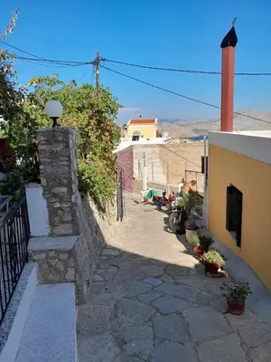 a stone walkway next to a building with a fence at 