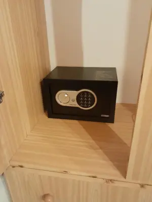 a microwave oven sitting inside of a wooden drawer at 