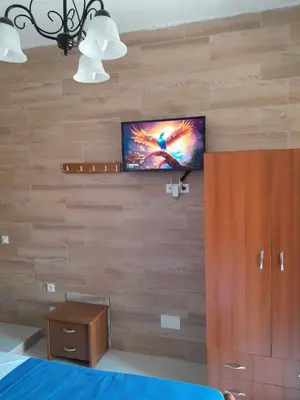 a bedroom with a wall with a tv on it at 