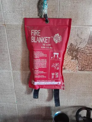 a fire blanket is hanging on a wall at 
