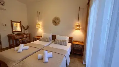 two beds in a hotel room with towels on them at ANGELOS STUDIOS 1-2 in Faliraki Rhodes-Ground Floor in Faliraki