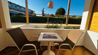 a small table and chairs in front of a window at ANGELOS STUDIOS 1-2 in Faliraki Rhodes-Ground Floor in Faliraki