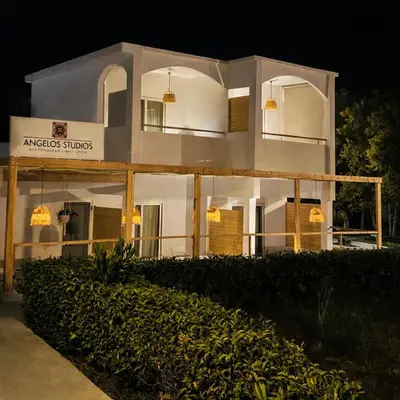 a large white building at night at ANGELOS STUDIOS 1-2 in Faliraki Rhodes-Ground Floor in Faliraki