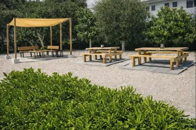 a group of picnic tables and a gazebo at ANGELOS STUDIOS 1-2 in Faliraki Rhodes-Ground Floor in Faliraki