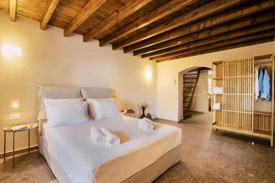 a bedroom with a large bed with towels on it at Rizes Traditional House in Phanaes