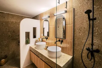 a bathroom with two sinks and a shower at Rizes Traditional House in Phanaes