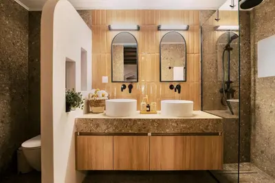 a bathroom with two sinks and a shower at Rizes Traditional House in Phanaes