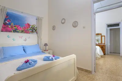 a bedroom with a bed with towels on it at Rhodes Heaven Jasmine in Malona Village