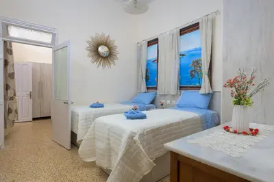 a bedroom with two beds and a mirror on the wall at Rhodes Heaven Jasmine in Malona Village