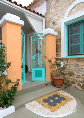 a front door of a house with a blue door at Rhodes Heaven Jasmine in Malona Village