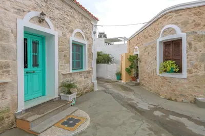 a house with a blue door and a street at Rhodes Heaven Jasmine in Malona Village