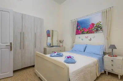 a bedroom with a bed and a painting on the wall at Rhodes Heaven Jasmine in Malona Village