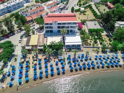 an overhead view of a building with blue umbrellas and the water at Lido Star in Faliraki