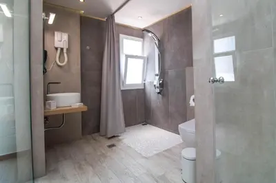 a bathroom with a shower and a toilet and a sink at Lido Star in Faliraki