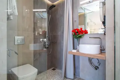 a bathroom with a toilet and a sink and a shower at Lido Star in Faliraki