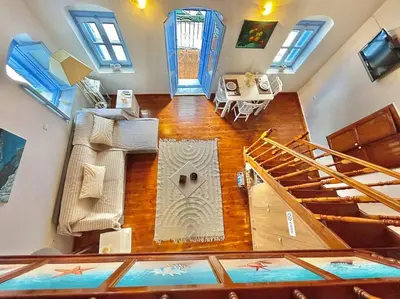 an overhead view of a living room with a staircase at Nikolakis, Seafront- Harbor view in Symi
