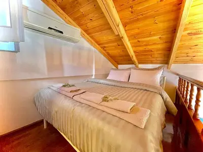 a bedroom with a bed with two towels on it at Nikolakis, Seafront- Harbor view in Symi