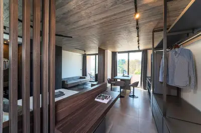 a room with wooden walls and a desk at Golden Sun Luxury Apartment Adults Only in Rhodes Town