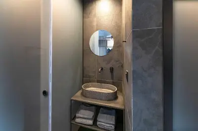 a bathroom with a sink and a mirror at Golden Sun Luxury Apartment Adults Only in Rhodes Town