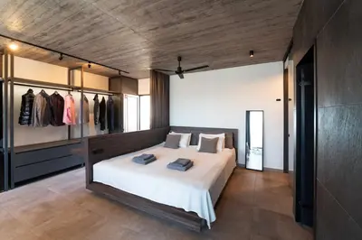 a bedroom with a large bed and a closet at Golden Sun Luxury Apartment Adults Only in Rhodes Town