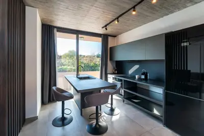 a kitchen with a table and two chairs in a room at Golden Sun Luxury Apartment Adults Only in Rhodes Town