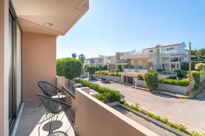 an apartment balcony with two chairs and a street at Golden Sun Luxury Apartment Adults Only in Rhodes Town