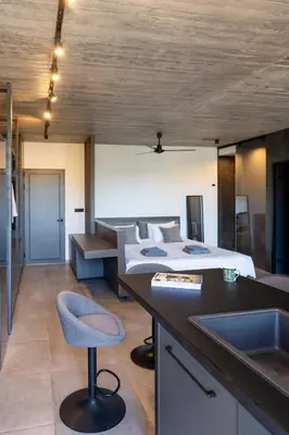 a bedroom with a bed and a desk and a sink at Golden Sun Luxury Apartment Adults Only in Rhodes Town