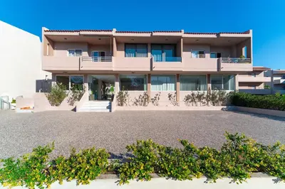 a building with a lot of plants in front of it at Golden Sun Luxury Apartment Adults Only in Rhodes Town