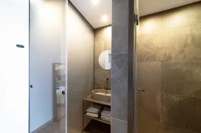 a bathroom with a shower and a sink at Golden Sun Luxury Apartment Adults Only in Rhodes Town