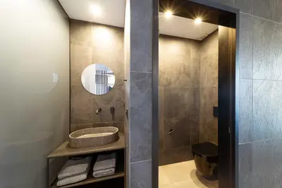 a bathroom with a sink and a mirror at Golden Sun Luxury Apartment Adults Only in Rhodes Town