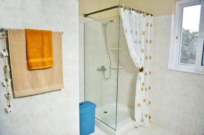 a bathroom with a shower with a shower curtain at Villa with private pool Zambakas in Kalithies