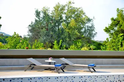 two chairs and a table on a patio at Villa with private pool Zambakas in Kalithies
