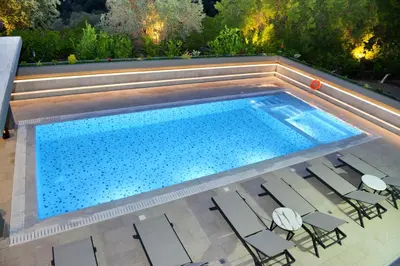 an overhead view of a swimming pool with chairs and tables at Villa with private pool Zambakas in Kalithies
