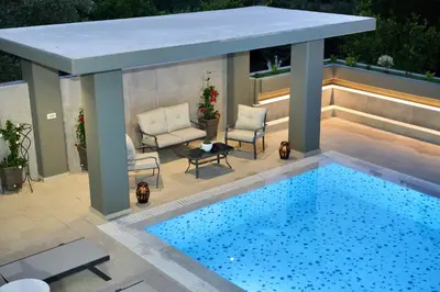 a swimming pool with a gazebo next to a swimming pool at Villa with private pool Zambakas in Kalithies