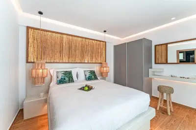 a bedroom with a white bed with a bowl of fruit on it at Villa Margarita Gennadi in Gennadi