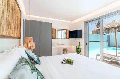 a bedroom with a bed and a swimming pool at Villa Margarita Gennadi in Gennadi