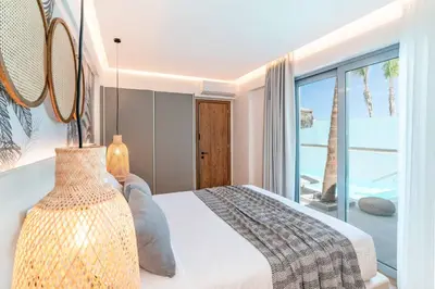 a bedroom with a bed with a view of the ocean at Villa Margarita Gennadi in Gennadi