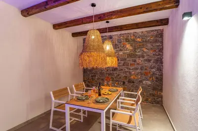 a dining room with a table and chairs at Villa Margarita Gennadi in Gennadi