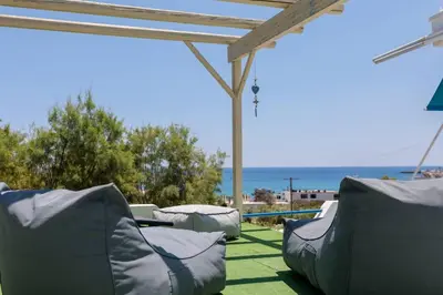a patio with two bean bags on the grass at Sylvia's Beach House in Stegna in Archangelos