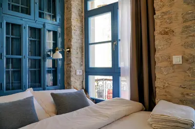a living room with a couch and a window at Little Gem Symi Boutique Studio in Symi