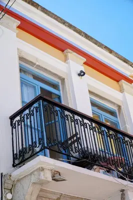 a building with a balcony and a window at Little Gem Symi Boutique Studio in Symi