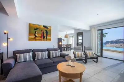 a living room with a couch and a table at Villa Karma Lindos in Líndos